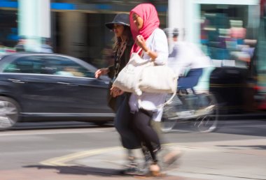 Londra, İngiltere - 9 Haziran 2019: Oxford caddesinde yürüyen insanların bulanık görüntü grubu, ana cadde ve butik alışverişiçin ana hedef. Nakliye çantalarını önemseyen insanlar.