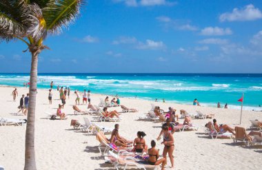 Meksika, Cancun - 15 Şubat 2018: Sahilde dinlenen, oynayan ve güneşlenen bir grup genç. Cancun Büyük Piramit eğlenceli kompleks