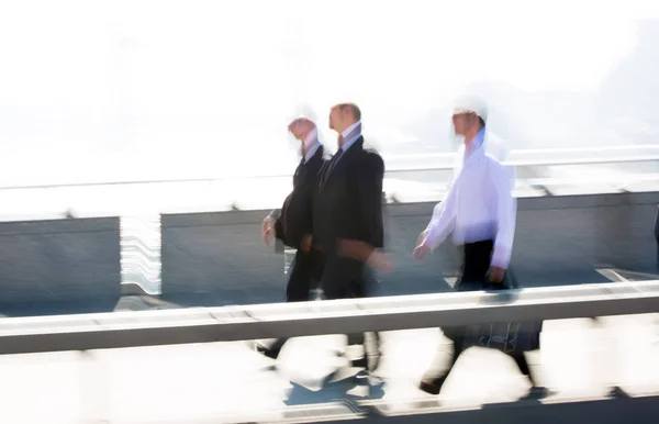 London, UK - April 19, 2018: Blurred image of office workers crossing the London bridge in early morning on the way to the City of London, the leading business and financial area in Europe. Rush hours