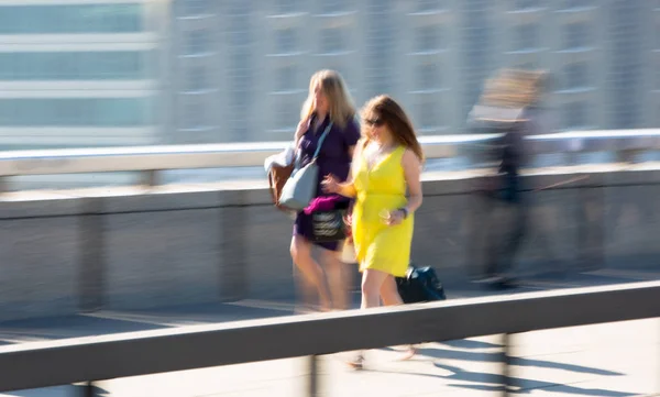 London, UK - April 19, 2018: Blurred image of office workers crossing the London bridge in early morning on the way to the City of London, the leading business and financial area in Europe. Rush hours