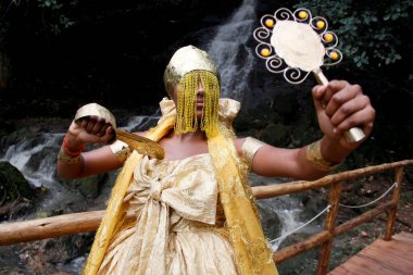 salvador, bahia / brazil - outobro 4, 2014: young man is seen at Parque Sao Bartolomeu in Salvador, wearing costumes from the orixa Oxum, a Candomble entity that reigns in fresh waters.