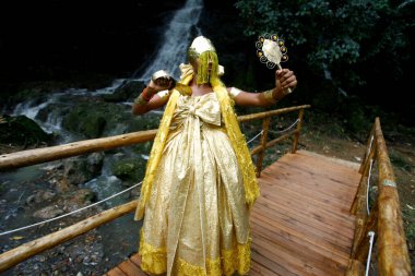 salvador, bahia / brazil - outobro 4, 2014: young man is seen at Parque Sao Bartolomeu in Salvador, wearing costumes from the orixa Oxum, a Candomble entity that reigns in fresh waters.