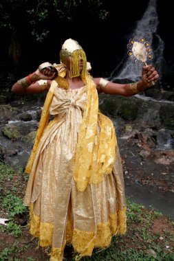 salvador, bahia / brazil - outobro 4, 2014: young man is seen at Parque Sao Bartolomeu in Salvador, wearing costumes from the orixa Oxum, a Candomble entity that reigns in fresh waters.