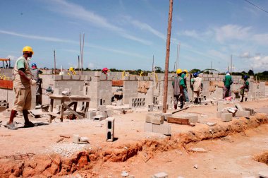 porto seguro, bahia / brazil - april 18, 2010: masons are seen working on the construction of popular houses in a Ferderal Government project in the city of Porto Seguro. 