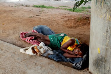 salvador, bahia / brazil - april 30, 2012: homeless people are seen under a viaduct near the Dique de Itororo in the city of Salvador. clipart