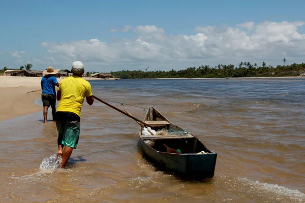 stock image conde, bahia / brazil - march 28, 2013: fishermen are seen in a small boat near the mouth of the Itapicuru river in the district of Siribinha in the city of Conde, north coast of Bahia.