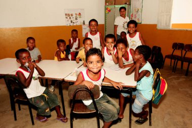 nova vicosa, bahia / brazil - december 30, 2009: quilombola children are seen in a rural school classroom in the district of Helvecia, in the municipality of Nova Vicosa. clipart