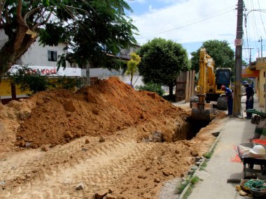 Eunapolis, Bahia / Brezilya - 17 Kasım 2010: kepçe makinesi Bahia 'nın güneyindeki Eunapolis şehrinde bir caddede bir kanalizasyon ağının uygulanması üzerinde çalışıyor.
