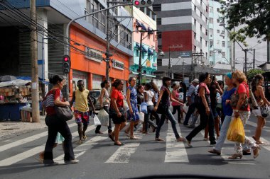 salvador, bahia / brazil - january 23, 2013: people are seen crossing the street in a pedestrian lane in downtown Salvador clipart