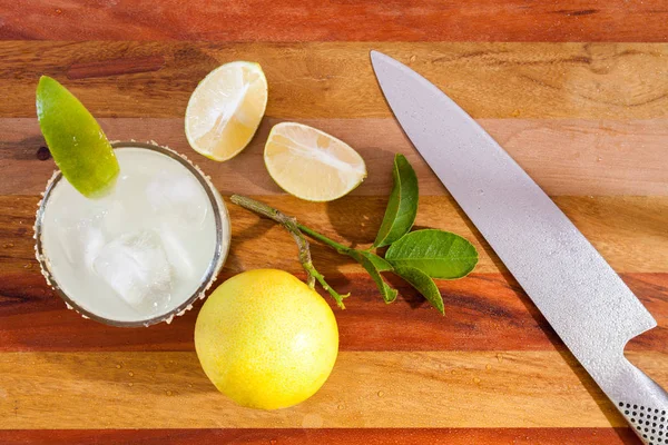 Key lime margarita garnerad med färsk lime i ett glas bar tabell kniv. Visa från ovan — Stockfoto