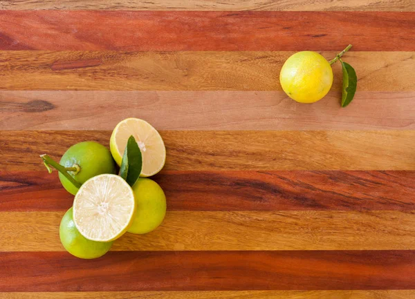 Key lime or Mexican lime on wooden table, one of main ingredient thai food and traditional pie. horizontal