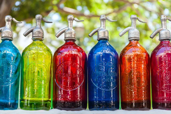 Antik forrásbarlang palackok világos, színes üveg, a bolhapiacon, Buenos Aires, Argentína — Stock Fotó