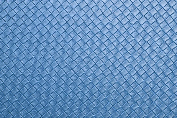 blue leather texture on sofa or cyan fabric and blank wall or top view empty table with grid and diamond or square pattern for background or wallpaper