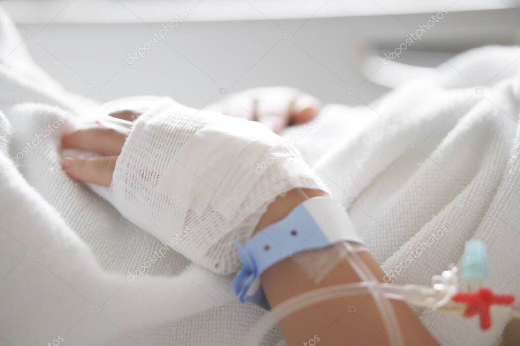 child or kid patients or sick in pediatric hospital with salt water or saline in blood vessels on hand for treatment healthcare and sleep rest on bed in hospital room from fever or infusion a disease