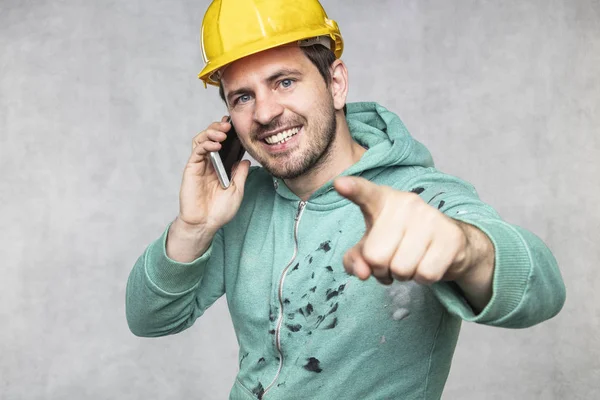 The building investor is talking on the phone and pointing to yo — Stock Photo, Image