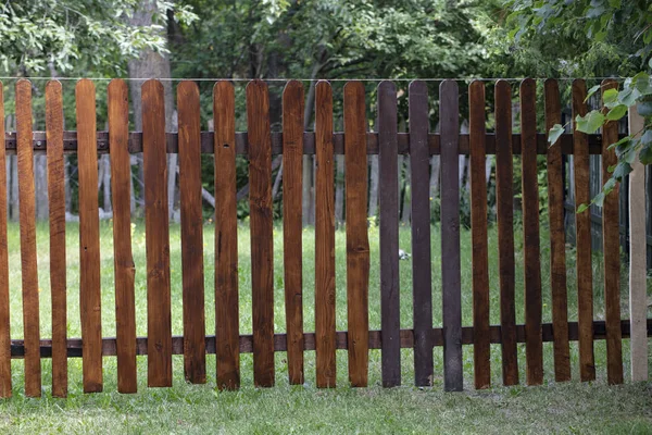 A wooden fence encloses the property — Stock Photo, Image