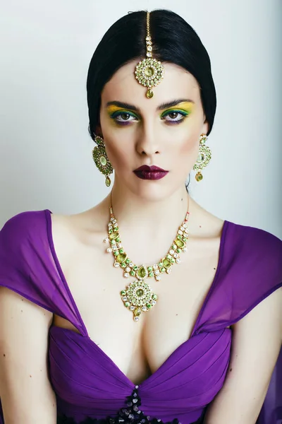 young pretty caucasian woman like indian in ethnic jewelry close