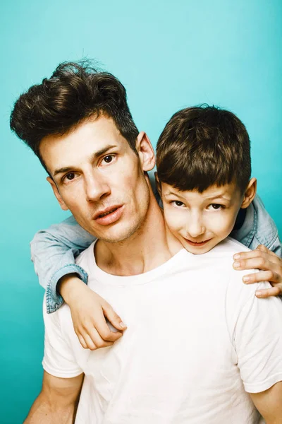 young pretty man model with little cute son playing together, li