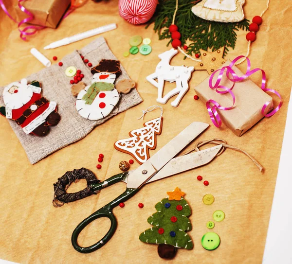 lot of stuff for handmade gifts, scissors, ribbon, paper with countryside pattern, ready for holiday concept, nobody home