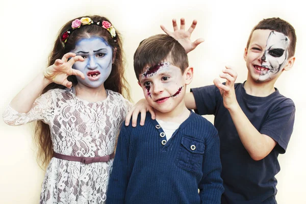 zombie apocalypse kids concept. Birthday party celebration facepaint on children dead bride, scar face, skeleton together having fun, halloween people