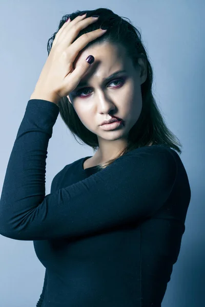 young pretty woman with blood from her nose closeup fashion makeup on halloween celebration, people abuse concept