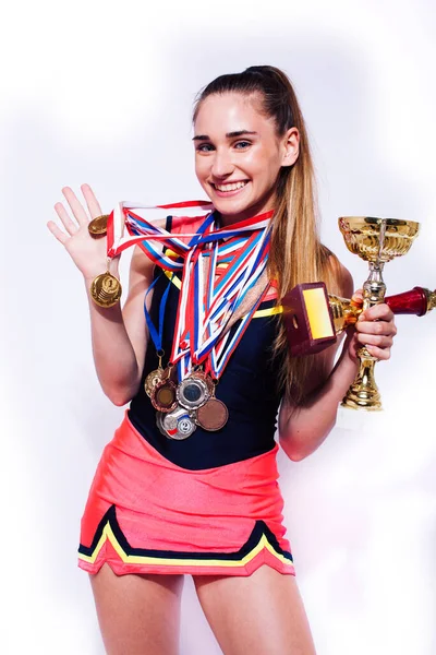 young smiling cheerleader girl with golden cups and price medals isolated on white background, lifestyle sport people concept
