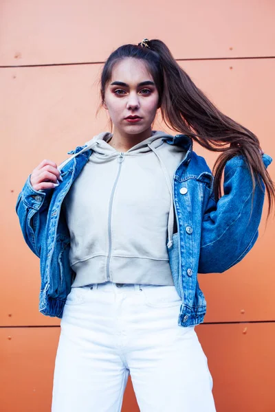 young pretty teenage girl posing cheerful happy smiling wearing street style outside in europe city, lifestyle people concept