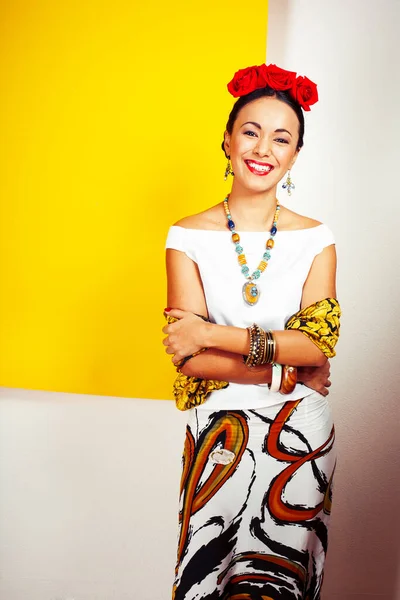 young pretty mexican woman smiling happy on yellow background, lifestyle people concept