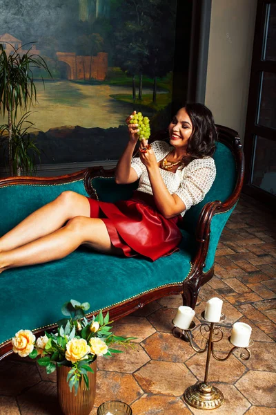 young pretty rich italian woman in golden luxury room interior, elegant styled hotel, people on vacation