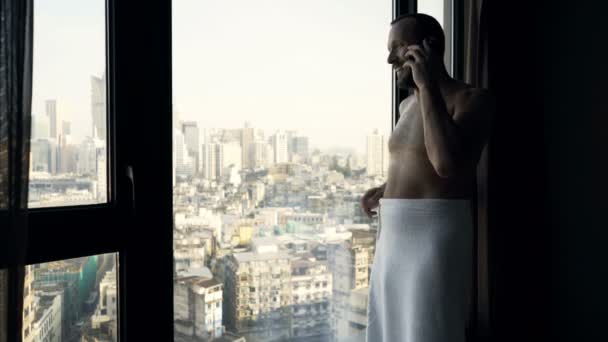 Happy Man Towel Talking Cellphone Standing Window Home — Stock Video