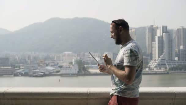 Hombre Joven Usando Tableta Pie Terraza Ciudad — Vídeo de stock