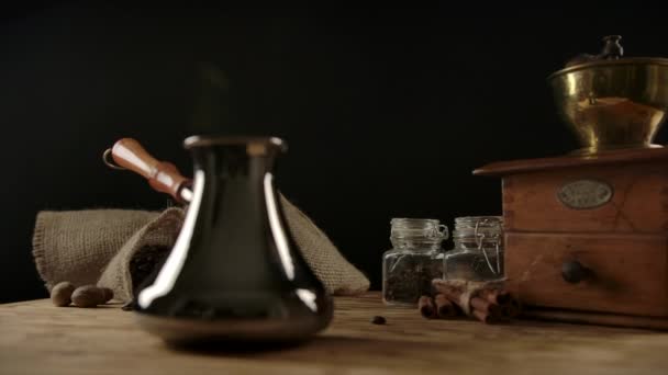 Traditional coffee cezve with wooden handle on wooden desk. Dolly shot — Stock Video