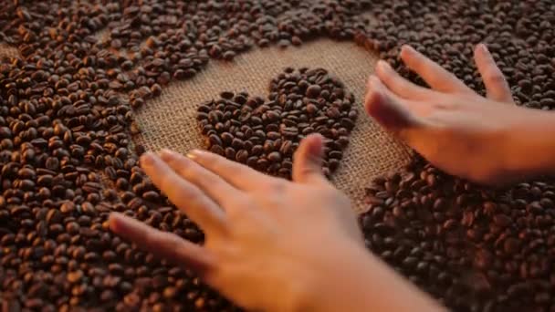 Vrouwen hand vorm hart vorm illustratie gemaakt van geroosterde arabica koffie granen — Stockvideo