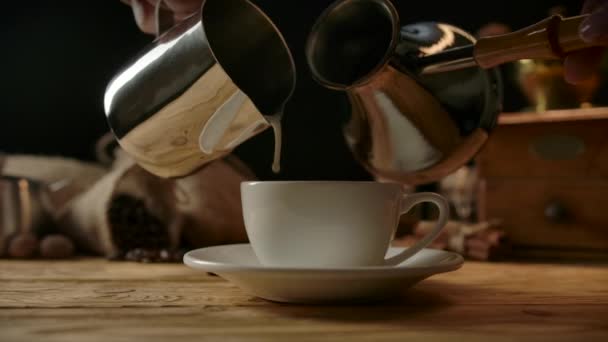Mixing traditional coffee from cezve and foamed milk straight in porcelain cup. — Stock Video