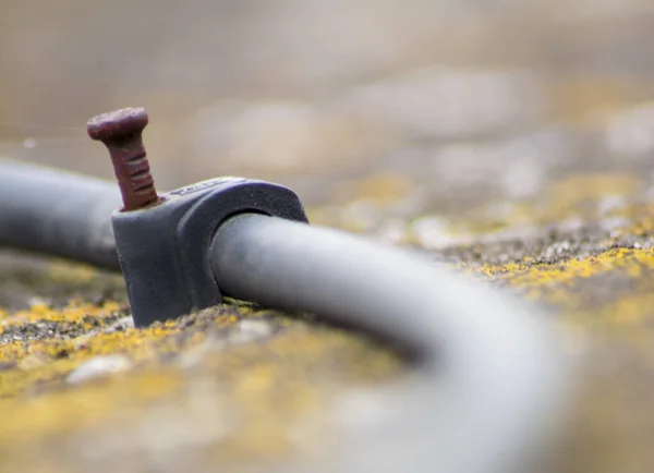 Coaxial Cable Fastener Rusty Nail Inserted Wall — Stock Photo, Image