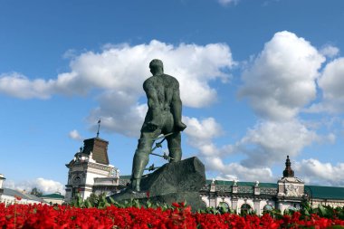Prisoner statue Monument to the Soviet Tatar poet and resistance fighter Musa Dzhalil (Mussa Jalil) near Kazan Kremlin Russia on bloody red flowers