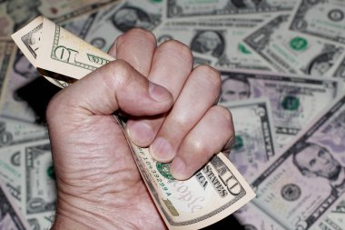 Yumruk, on dolarlık banknotun etrafında sıkışıyor. İş geçmişi