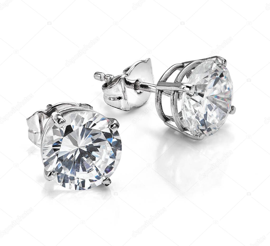 Big diamond earrings isolated on white background. Diamond earrings featuring four claw diamond stud earring design in white gold or platinum.