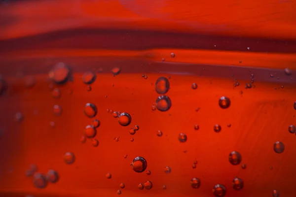 Bubbles in a red oil liquid — Stock Photo, Image