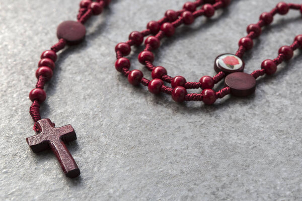 Red rosary on a stone background