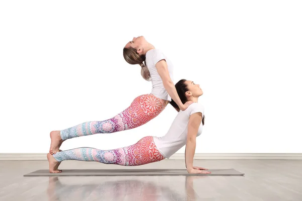 Young female acrobats make beautiful acrobatic poses