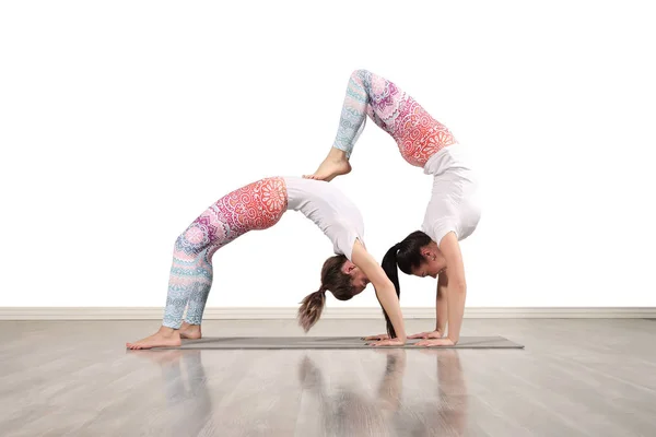 Young female acrobats make beautiful acrobatic poses