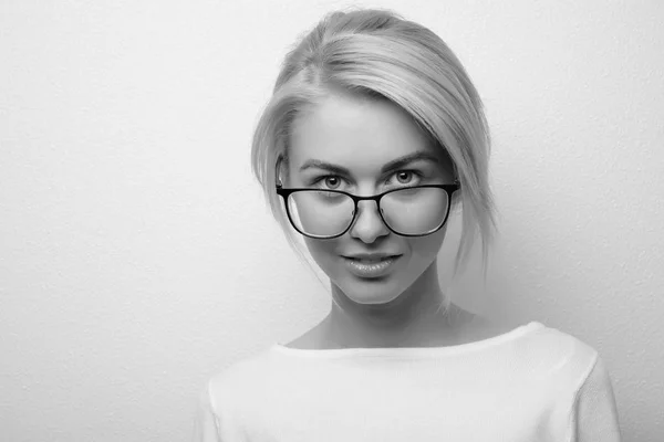 Black and white portrait closeup. Young woman in glasses