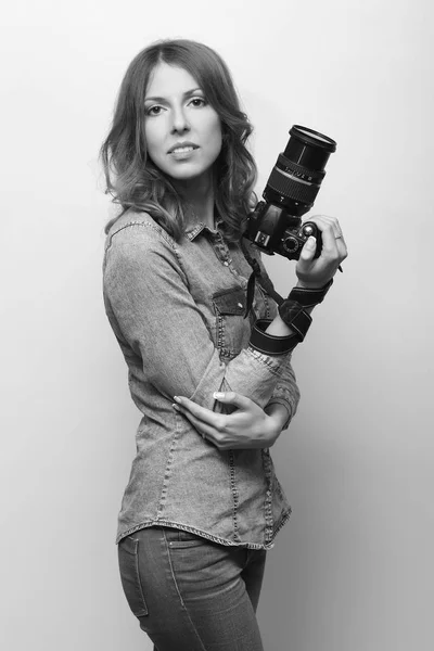 Beautiful young positive girl with camera — Stock Photo, Image