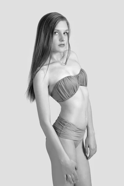 Slanke lichaam van een jonge vrouw in bikini op wit. Meisje met gezonde sportief figuur — Stockfoto