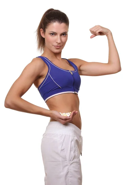 Close up of fitness woman taking pill — Stock Photo, Image