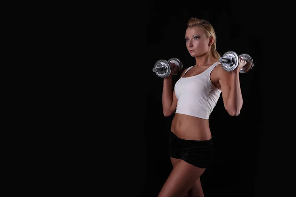 Fitness woman in doing exercises with dumbells. — Stock Photo, Image