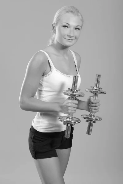 Fitness woman in doing exercises with dumbells. — Stock Photo, Image
