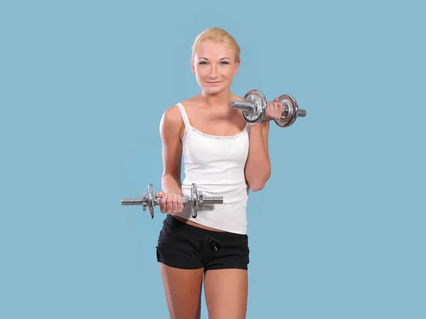 Fitness woman in doing exercises with dumbells. — Stock Photo, Image