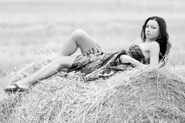 Young free woman in a field with hay — Stock Photo, Image